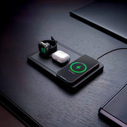 Tidy desk charging station organizer with devices and plants.