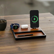 An Apple all in one charger powering an iPhone, Apple Watch, and AirPods on a desk.