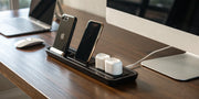A 2-in-1 MagSafe charger stand simultaneously charging an iPhone and AirPods.