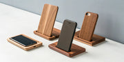 A collection of premium wood iPhone charging stations in various designs.