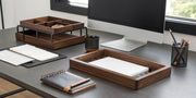 A modern walnut desk organizer set on a tidy desk.