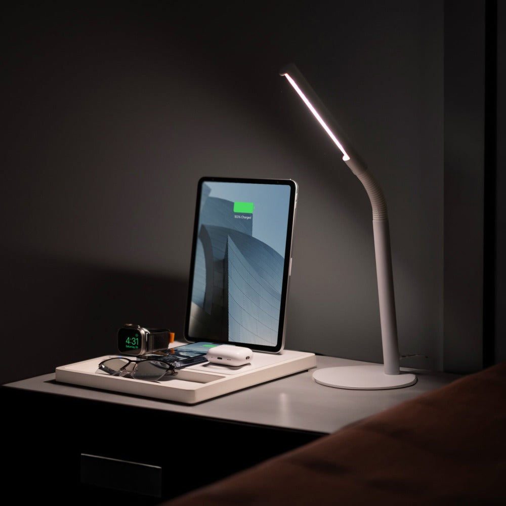 All-in-one charging station for Apple products on a desk with an iPhone, Watch, and AirPods.