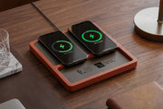 Premium wireless charging station on walnut wood nightstand with iPhone and AirPods charging