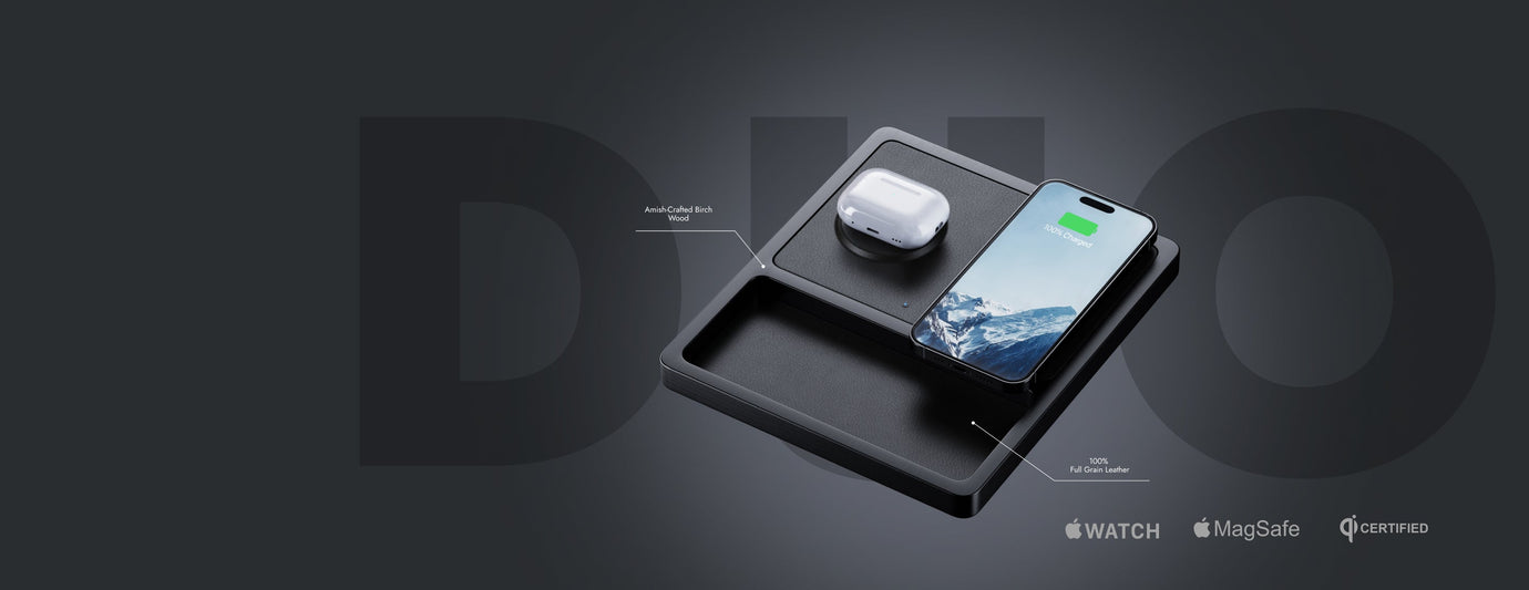 Premium wood NYTSTND DUO charger powering an iPhone and Apple Watch on a desk.