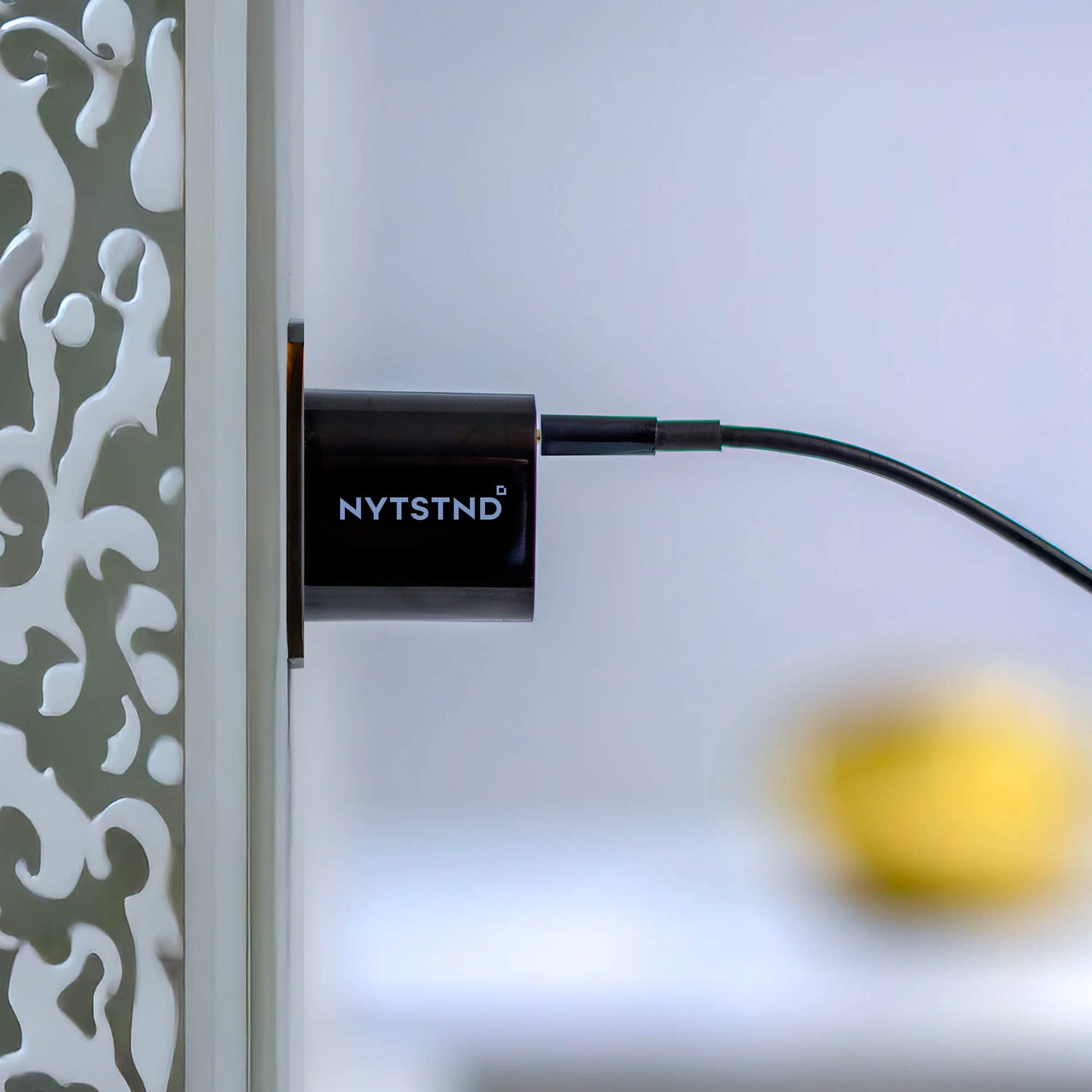 A single PD wall charger powering a laptop, smartphone, and tablet on a desk.