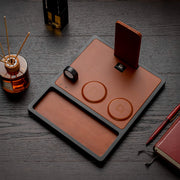 A smartphone charging on the best wooden wireless charger on a stylish desk.
