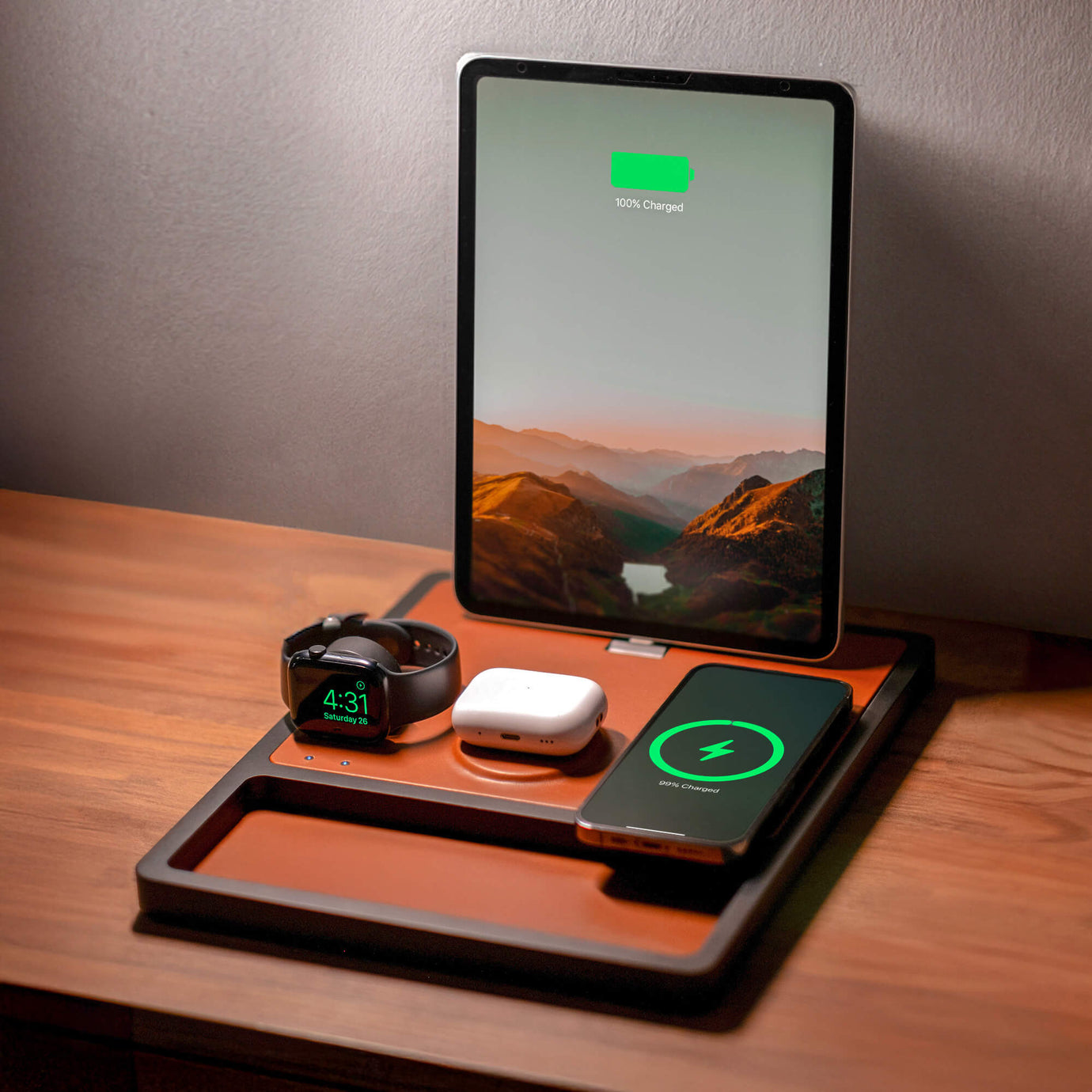 A wooden nightstand charging dock for an iPhone, holding multiple Apple devices.