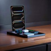 A wooden executive desk charging hub for an iPhone, Apple Watch, and AirPods.