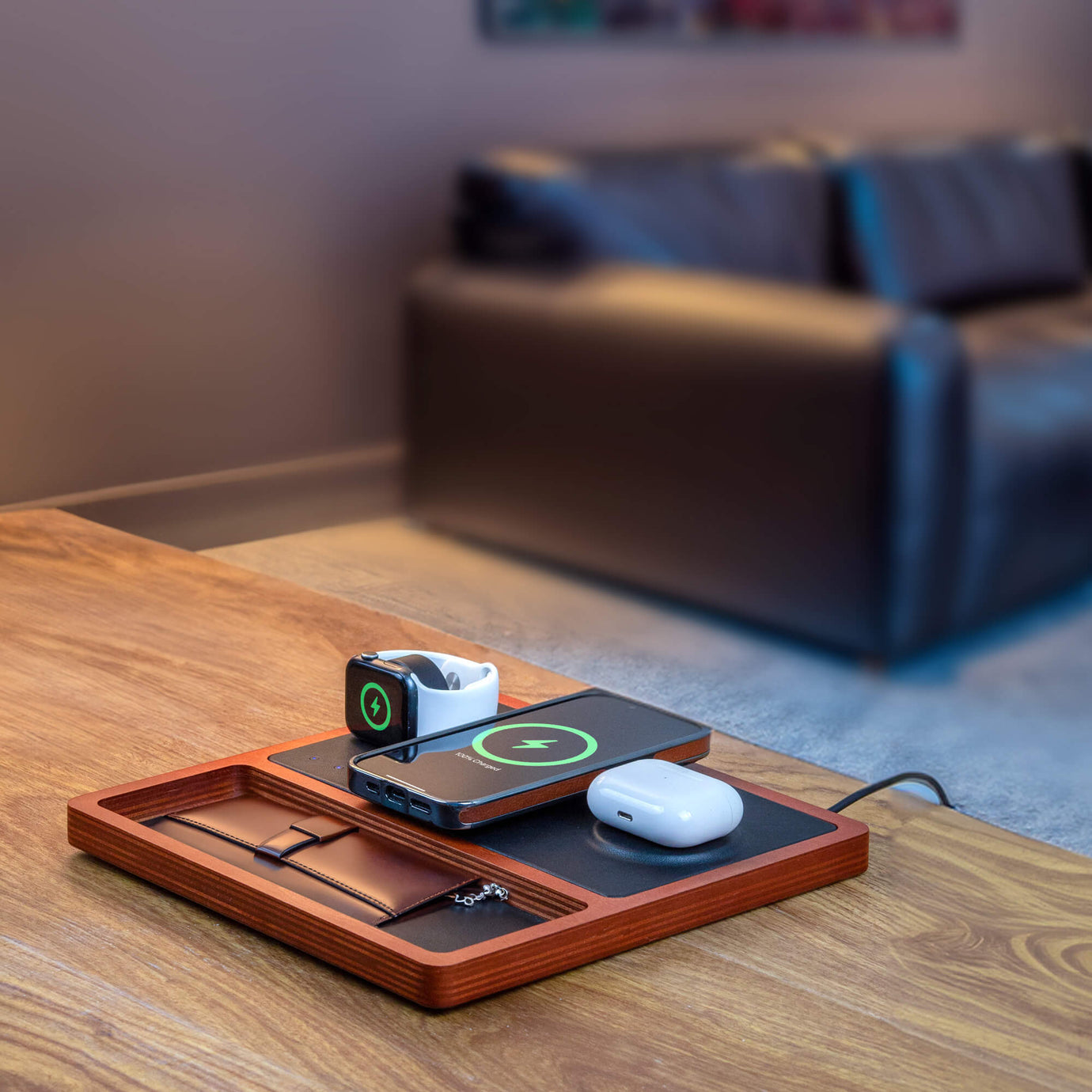 A sleek all-in-one charger for Apple products neatly charging an iPhone and AirPods.
