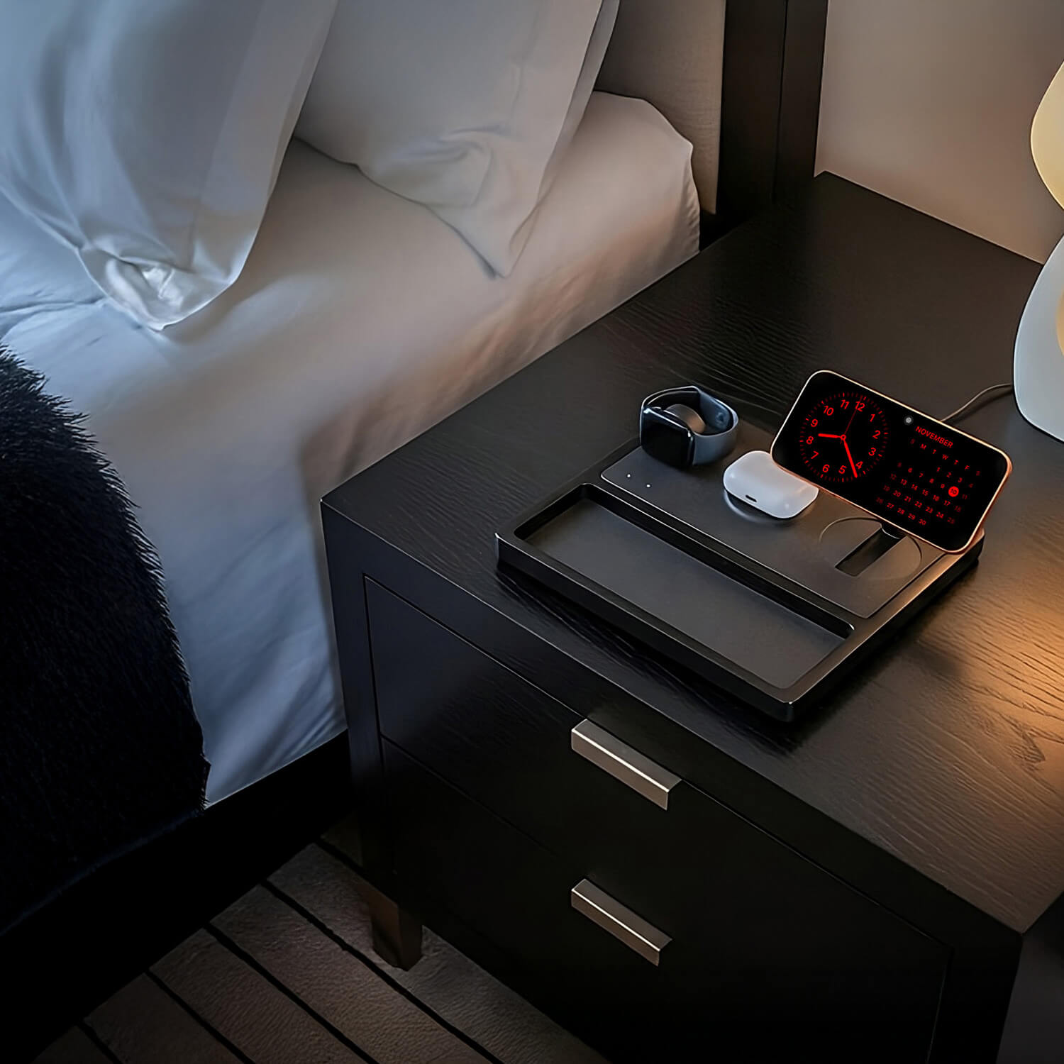 Luxury wood charging station wirelessly powering a phone, watch, and earbuds.