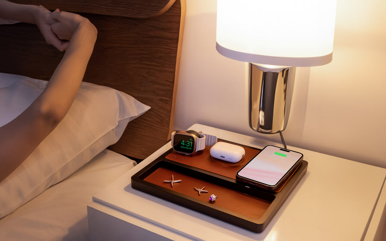 A wooden mens nightstand organizer with a wireless charging station for a phone, watch, and keys.