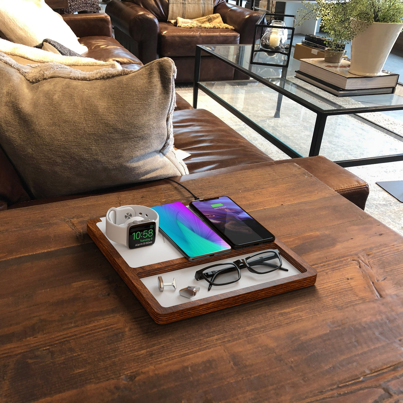 Apple bedside charging station neatly organizing and charging an iPhone, Apple Watch, and AirPods.