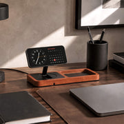 Tablet, smartphone, and earbuds charging wirelessly on a modern charging station.