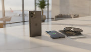 Premium MagSafe power bank on marble counter next to iPhone, passport, and sunglasses
