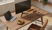 A professional wooden desk setup with a premium wireless charging station, iPhone, laptop, and organized workspace accessories in natural light