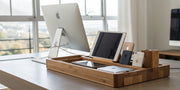 Wooden multi-device charging station neatly organizing a tablet and smartphones.