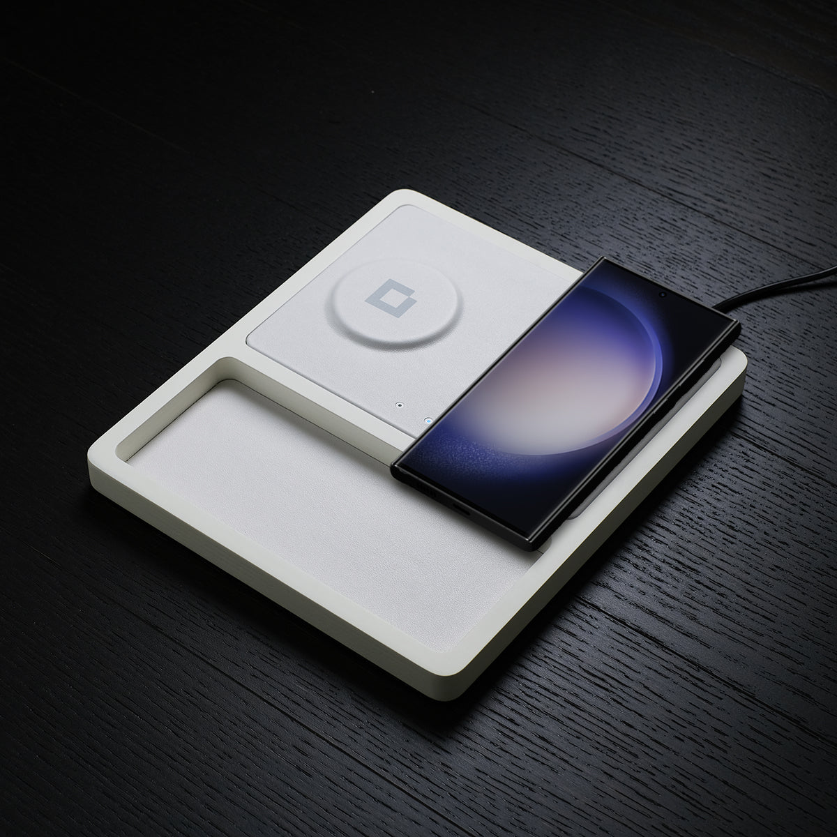 A Samsung wireless charger stand simultaneously charging a phone, watch, and earbuds.