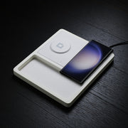 A Samsung wireless charger stand simultaneously charging a phone, watch, and earbuds.