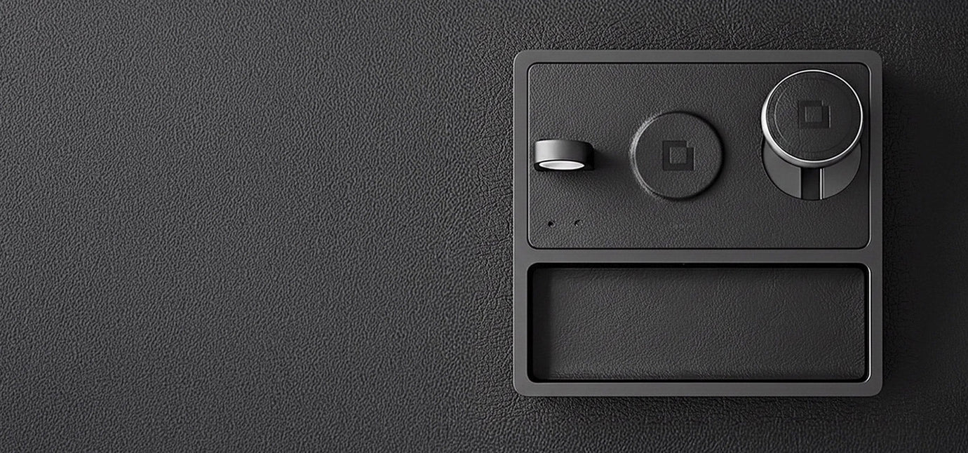 A minimalist iPhone charging dock powering a phone, smartwatch, and earbuds.