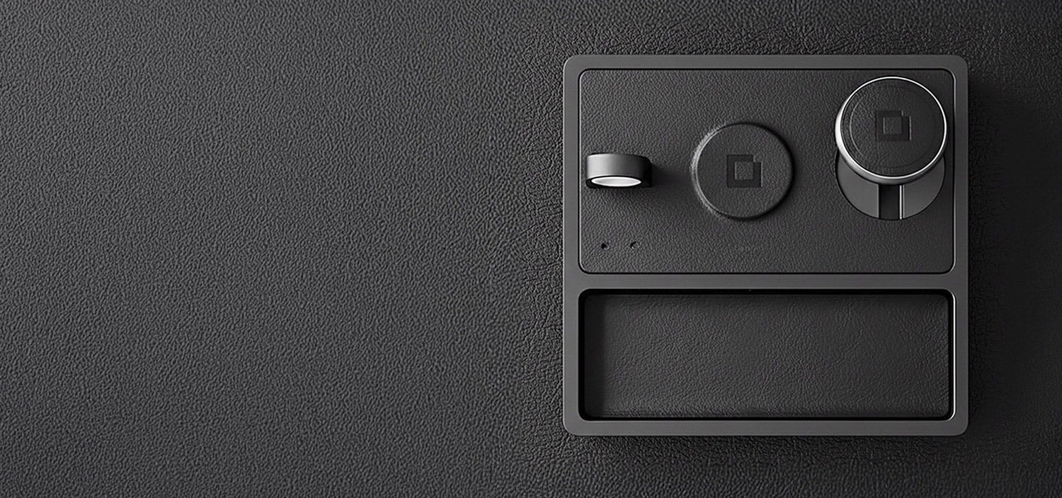 A minimalist iPhone charging dock powering a phone, smartwatch, and earbuds.