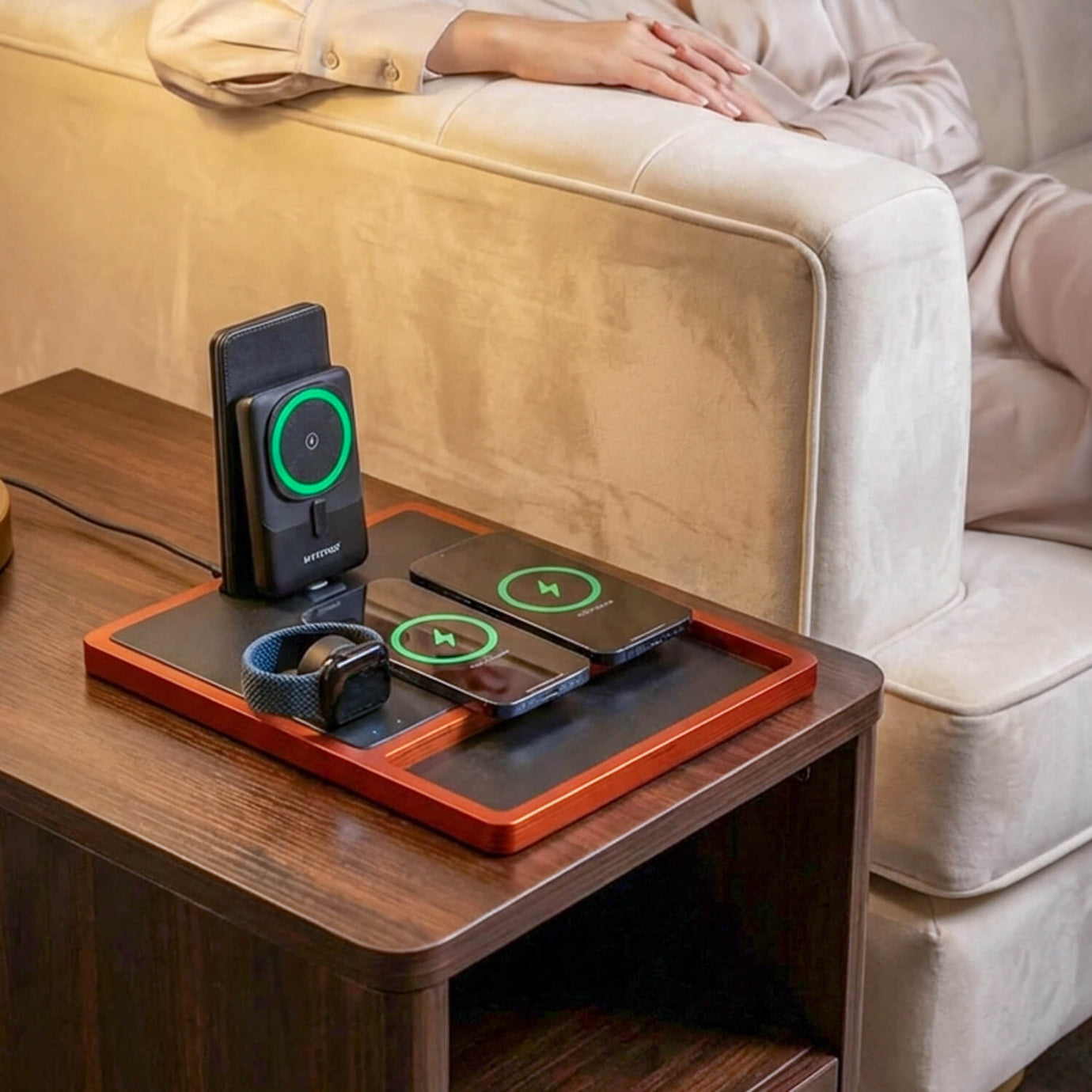 A multi-device iPhone charging station powering an iPhone, Apple Watch, and AirPods on a desk.