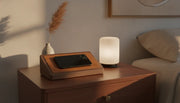 Walnut wood wireless charging station with leather surface on a polished nightstand