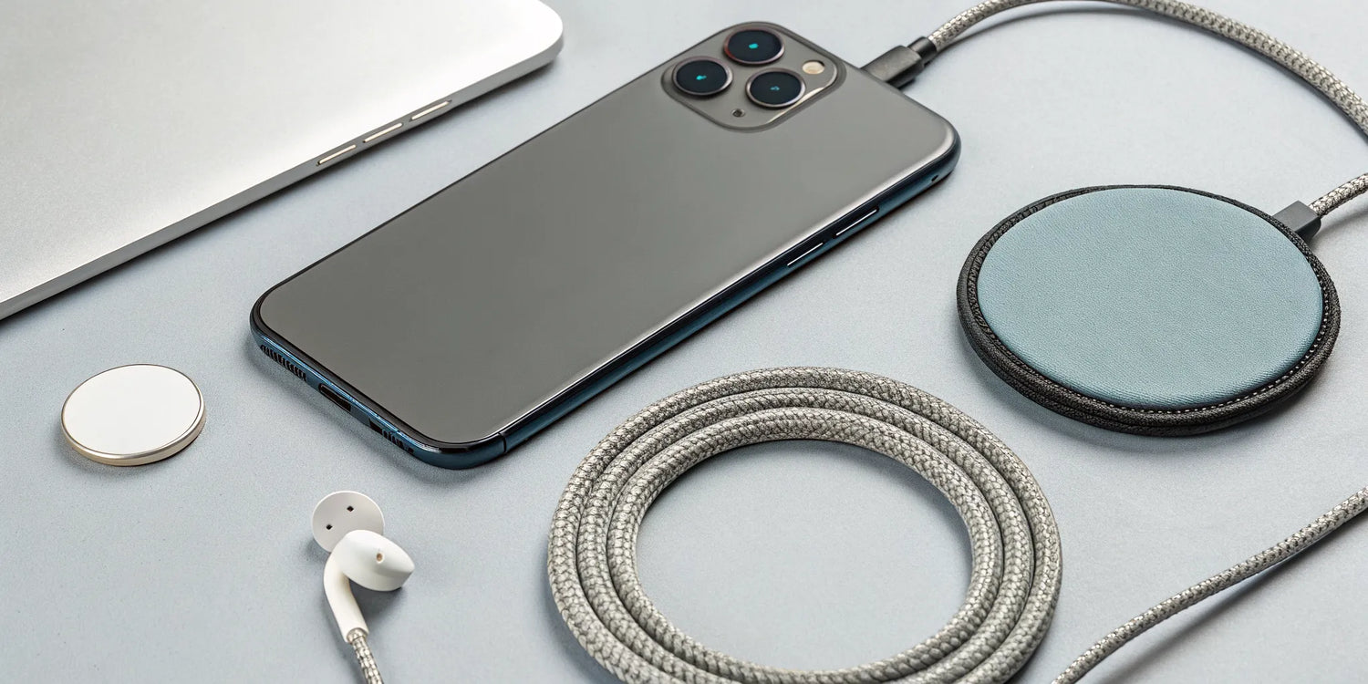 A smartphone magnetically attached to a Qi2 MagSafe charger.