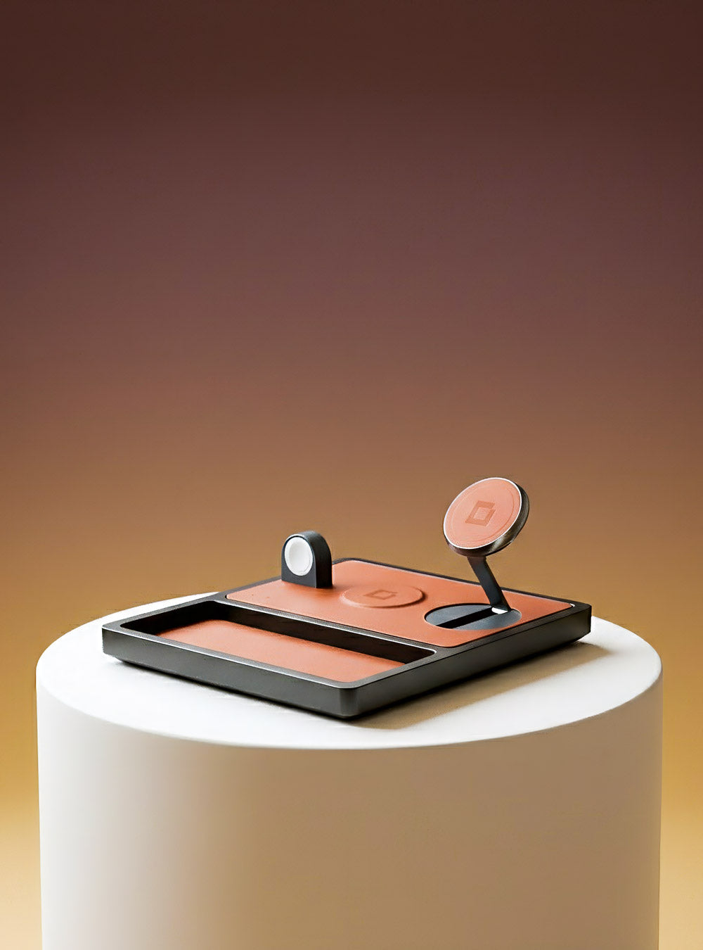 Executive leather charging valet for a desk organizing a phone, wallet, and accessories.