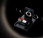 A 3-in-1 charging dock on a nightstand charging a phone, watch, and earbuds.