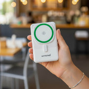 A slim magnetic battery pack for travel charging a phone at an airport.