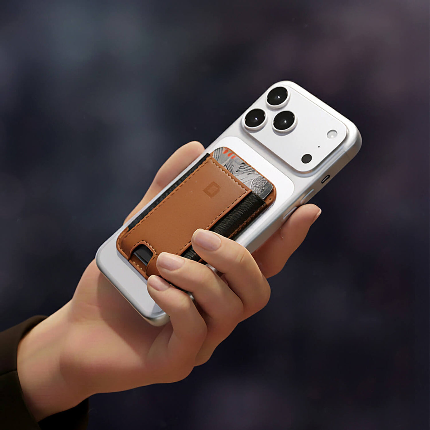 Leather MagSafe wallet attached to an iPhone.