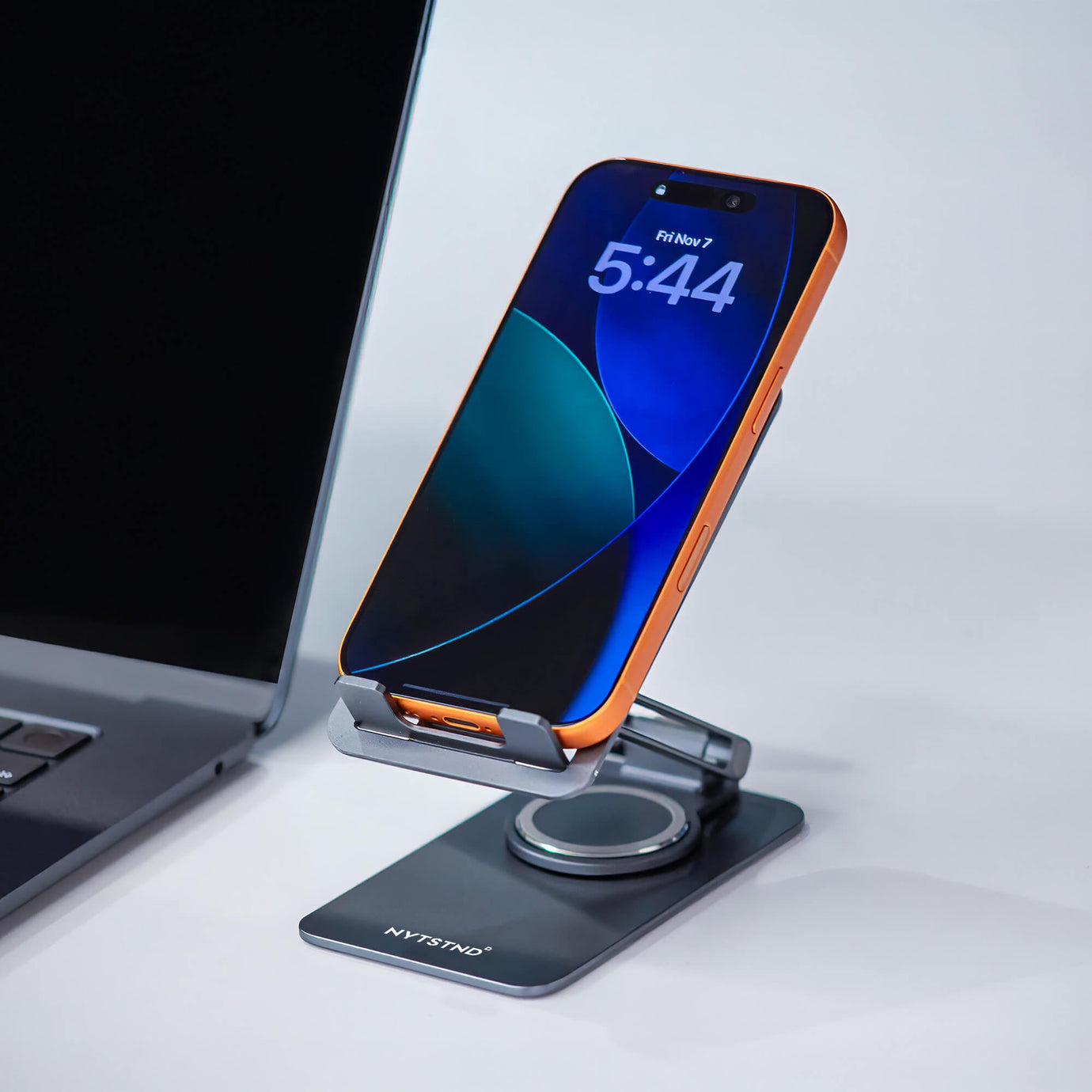 The benefits of a foldable charging station for an organized, multi-device setup on a desk.