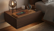 Premium wooden wireless charging station on a bedroom nightstand with iPhone and Apple Watch charging