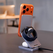 A compact collapsible charging pad for travel, charging a phone and watch.