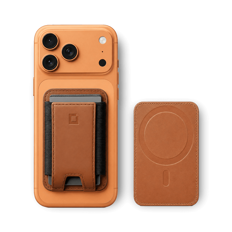 Luxury full-grain leather MagSafe wallet on a wood surface next to an iPhone