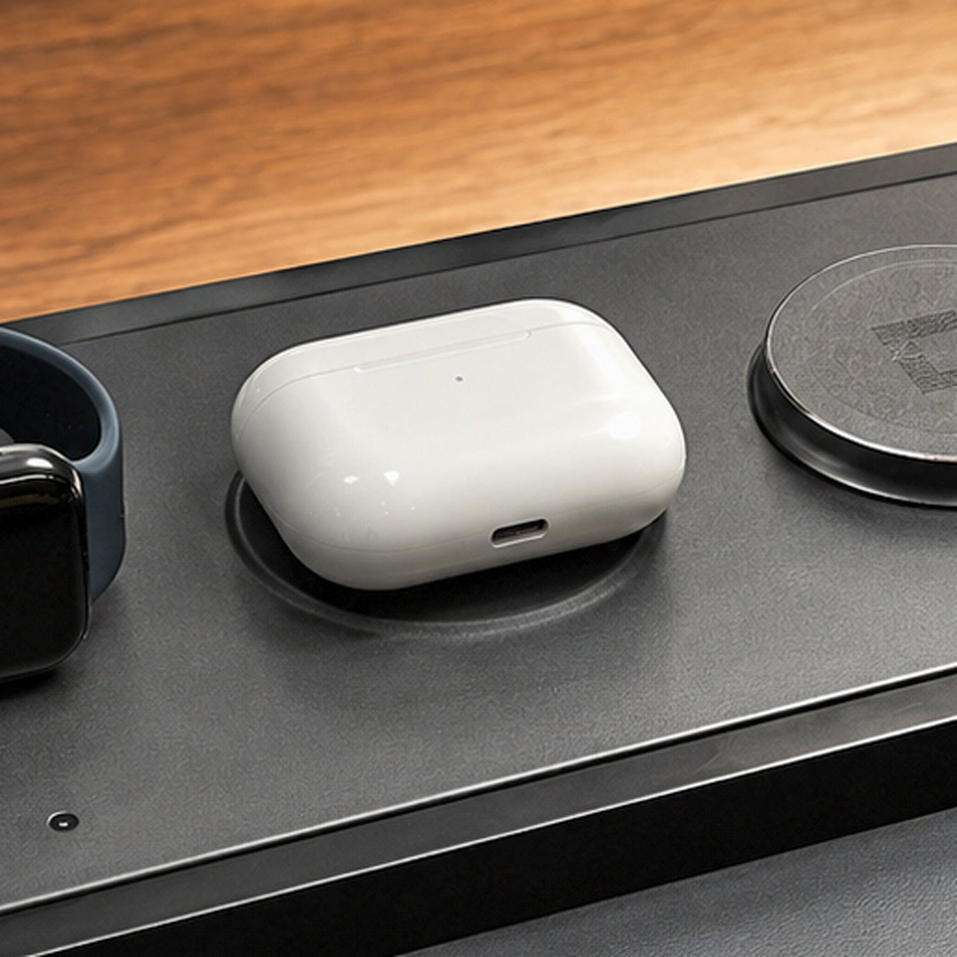 NYTSTND DUO TRAY Black — angled lifestyle hero shot showing charger on a desk with devices charging