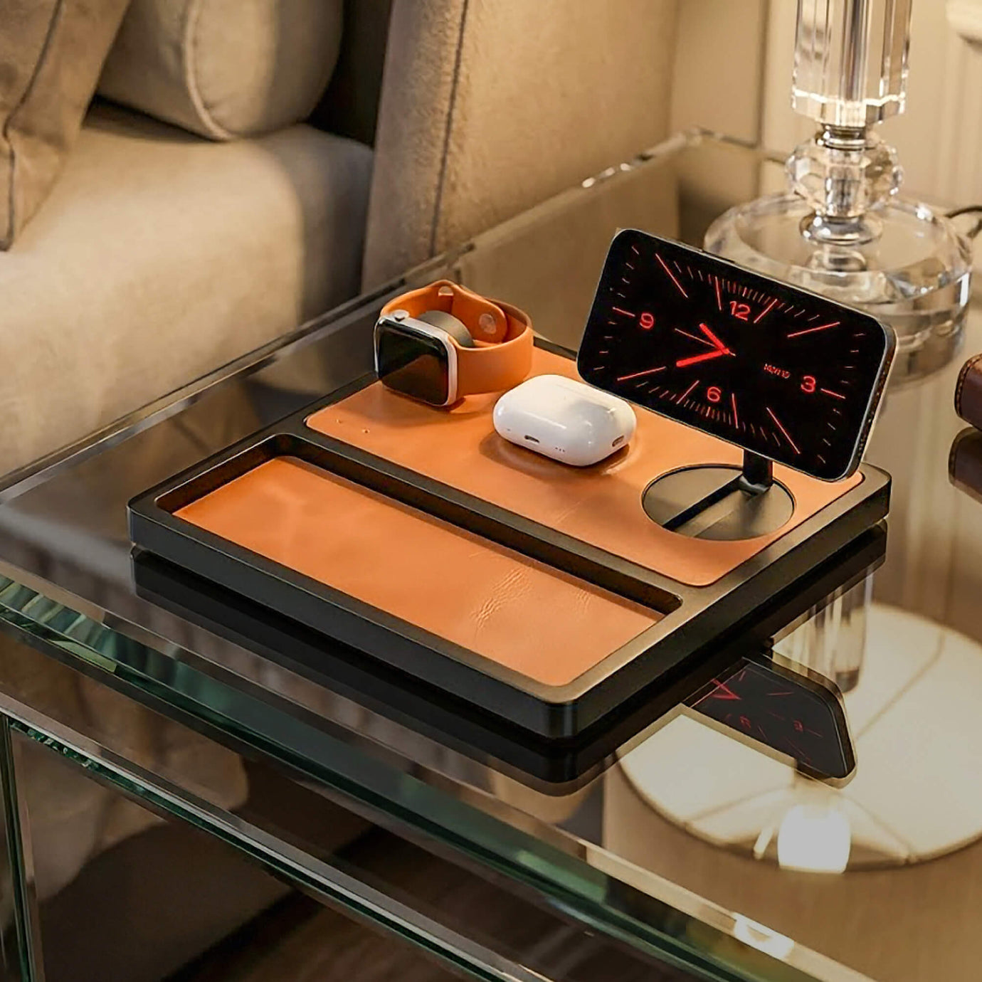 NYTSTND TRIO TRAY Qi2 3-in-1 MagSafe Saddle Brown on Black — angled lifestyle hero showing tray on bedside table