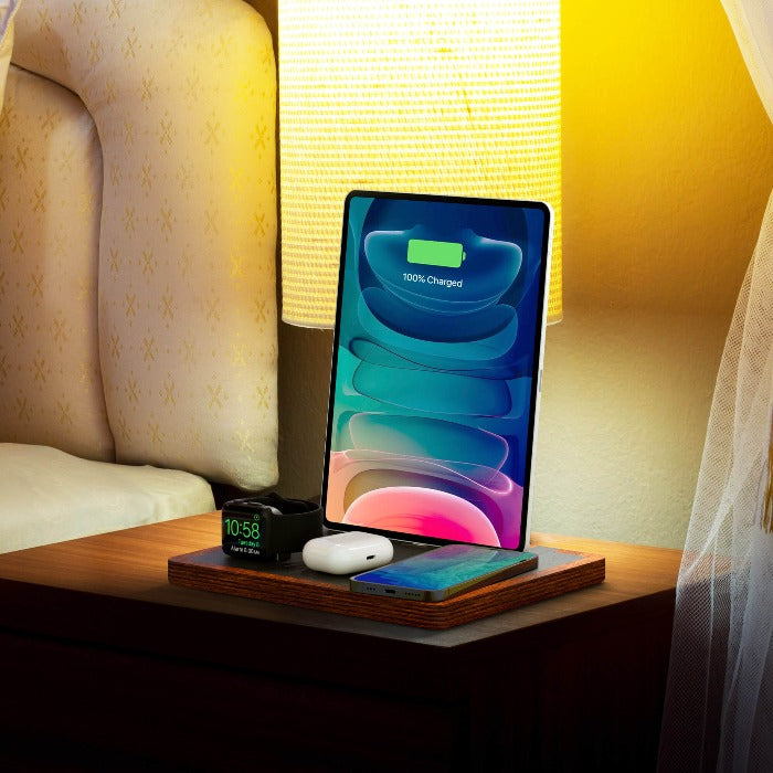 NYTSTND QUAD black top, oak base lifestyle picture on nightstand, charging Apple Watch, AirPods, iPhone, next to the light