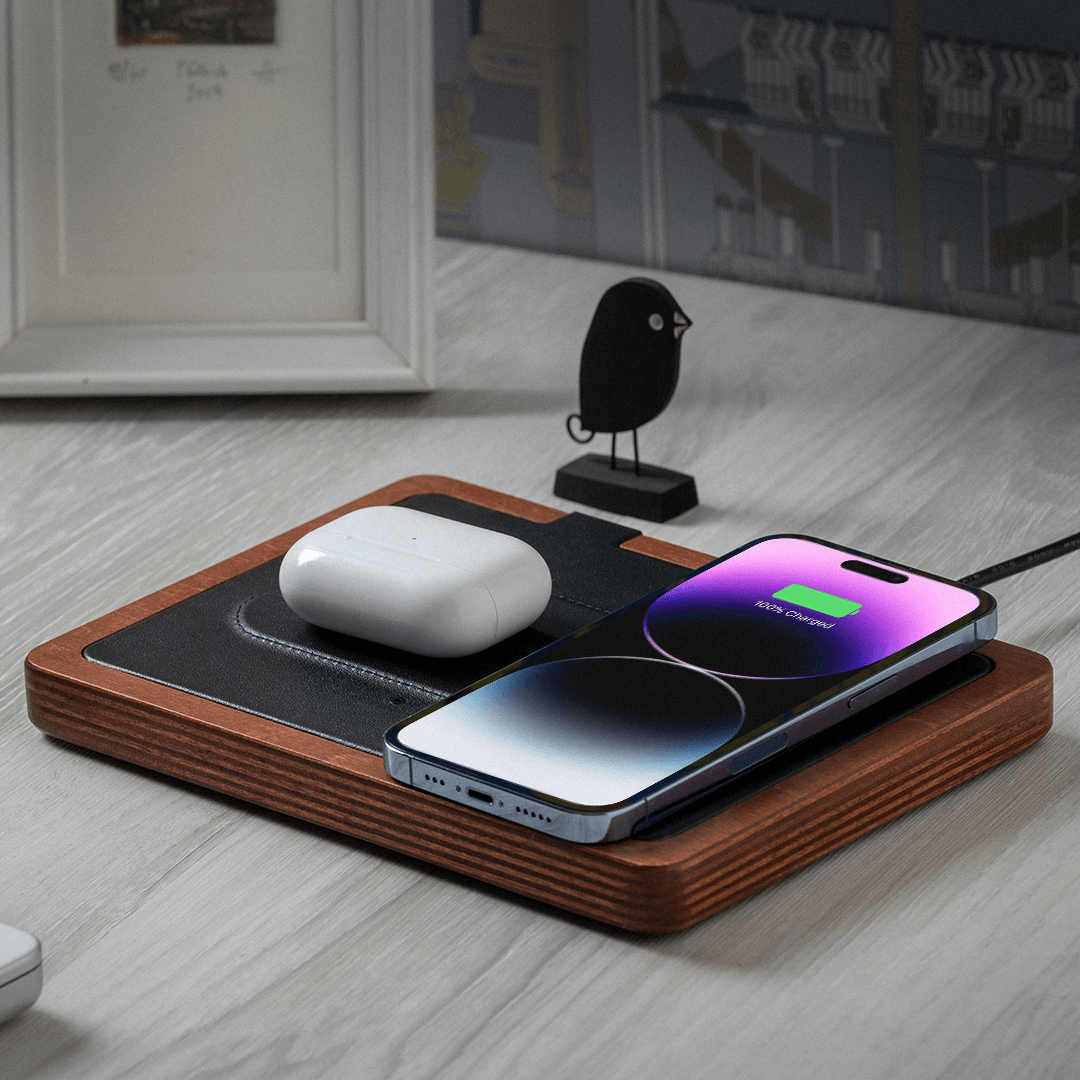 NYTSTND DUO lifestyle picture on table, charging AirPods, iPhone