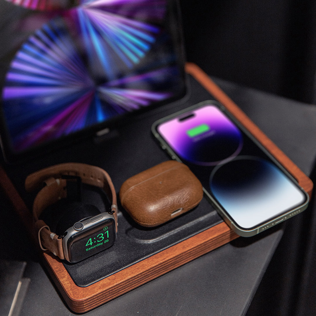 NYTSTND QUAD black top, oak base lifestyle picture on nightstand charging Apple Watch, AirPods, iPhone on table